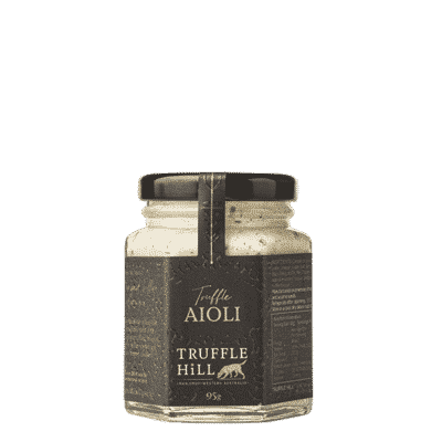 A hexagonal glass jar with a black label branded Truffle Hill. Label describes Truffle Aioli