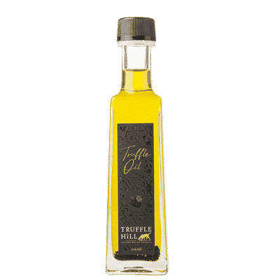 Golden glass bottle with a black label. Truffle Hill brand Truffle Oil.