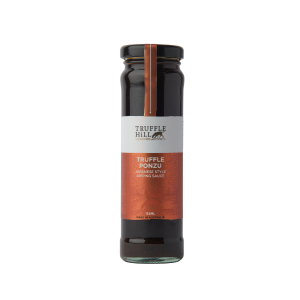 A tall round jar filled with a dark liquid. Black label with truffle hill brand on it and marked as Truffle Ponzu.