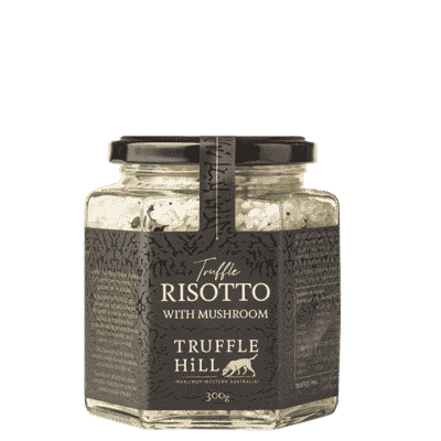 Hexagonal glass jar filled with rice. Has a black label with Truffle Hill brand and Truffle Risotto description.